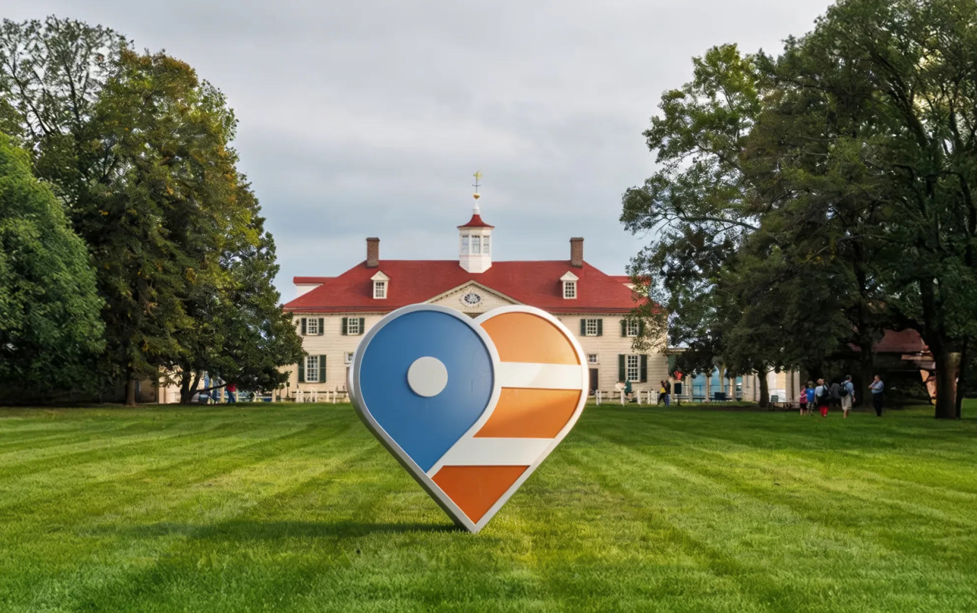 A large map-pin-shaped heart sculpture in fxva blue and orange stripes, standing on the lawn in front of Mount Vernon.